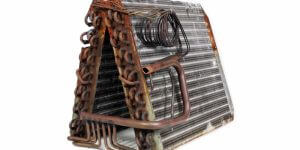 old leaking evaporator coil removed from HVAC system