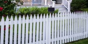 white picket fence in front of house
