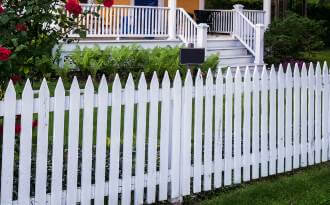 white picket fence in front of house