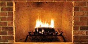 brick fireplace with fire burning