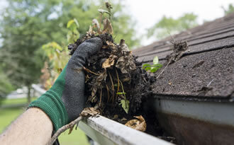 hand cleaning rain gutters
