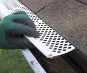 Contractor installing gutter guards