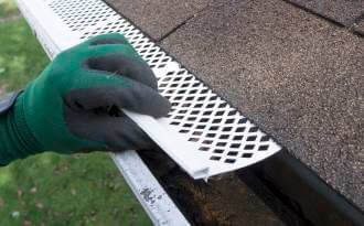 Contractor installing gutter guards
