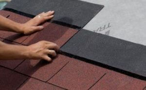roofer replacing asphalt shingle roof