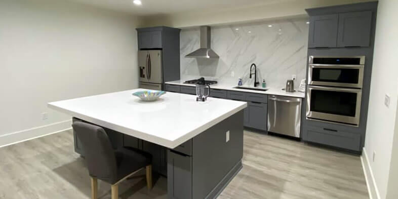 granite island installed in basement kitchen