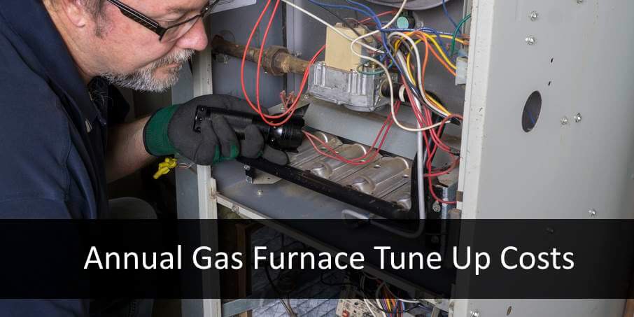 hvac service man checking furnace tune up costs maintenance
