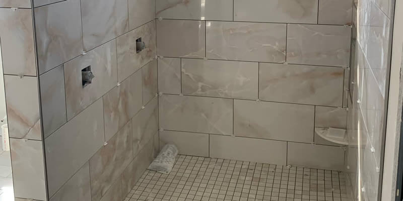 new tile installed in a shower before grout