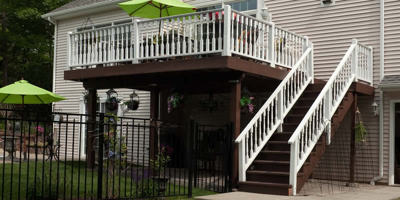 stained deck with white railing on new stairs