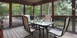 screened in porch with wood deck