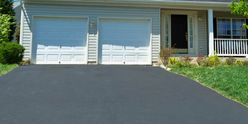 replacement asphalt driveway installed to a home