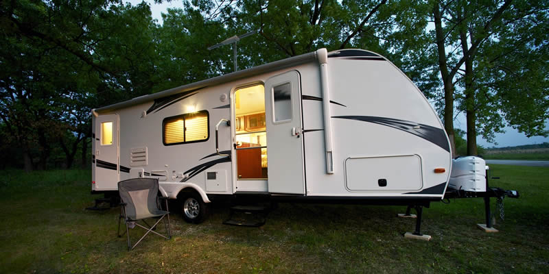 rv travel trailer with electricity running at night
