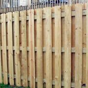 natural finish shadowbox fence installed around home