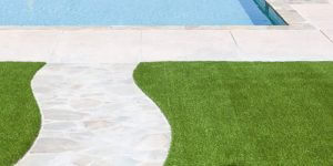 artificial grass installed by pool and curved walkway