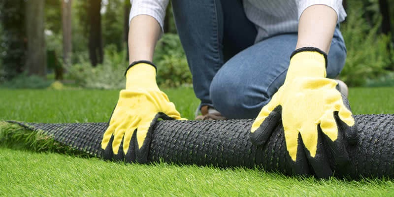 landscaper installing artificial grass