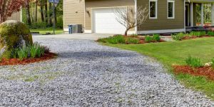 gravel driveway leading up to country home