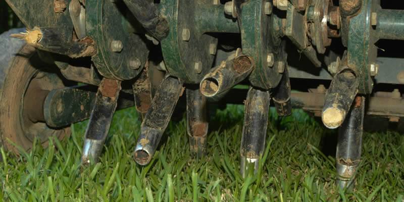 core aeration machine with tines visible