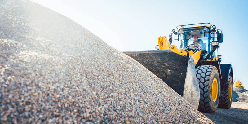 gravel being scooped by a big bucket loader